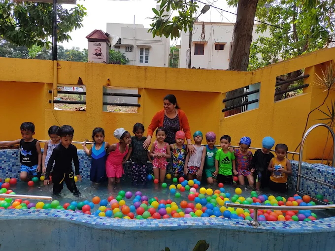 Children playing in colourful outdoor ball pool