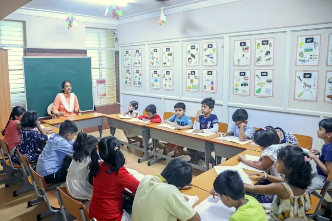 Teacher leading a classroom writing lesson