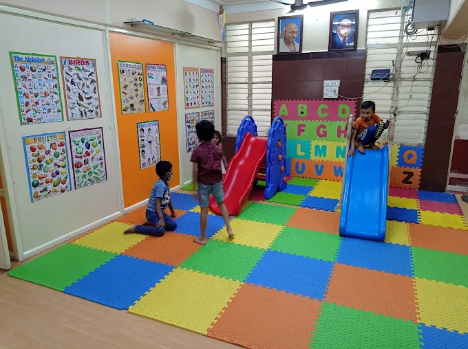Children playing on indoor slide activity mats