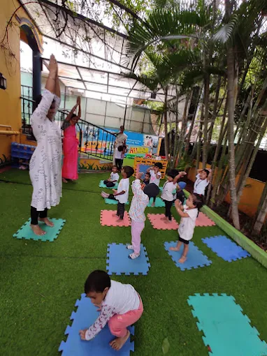 Teacher guiding outdoor yoga session on lawn