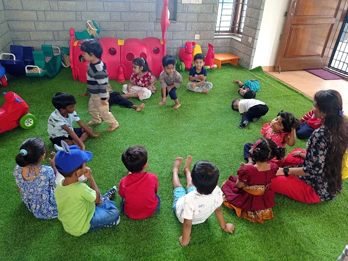 Outdoor circle time with teacher on lawn