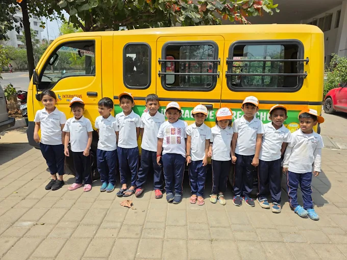 Students in uniform posing by the school van