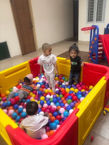 Children playing together in a ball pit