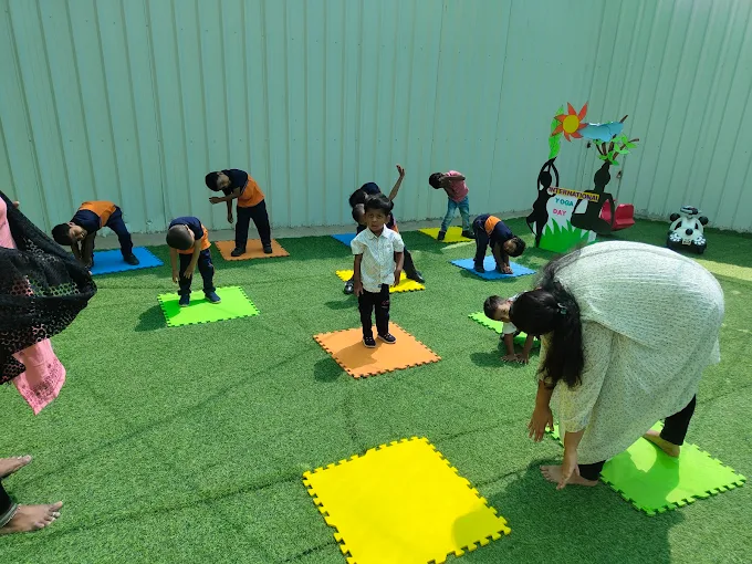 Kids and teacher doing outdoor yoga on mats