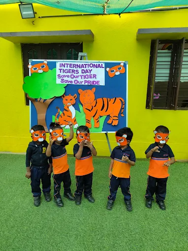 Children in tiger masks for Tiger Day activity