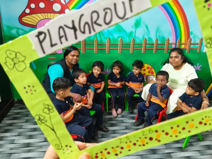 Playgroup children posing with photo frame