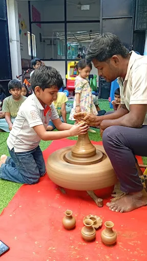 Child learning pottery on a wheel