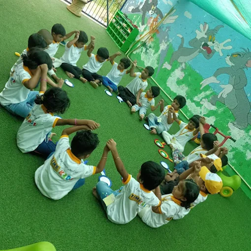 Children in a circle holding hands outdoors