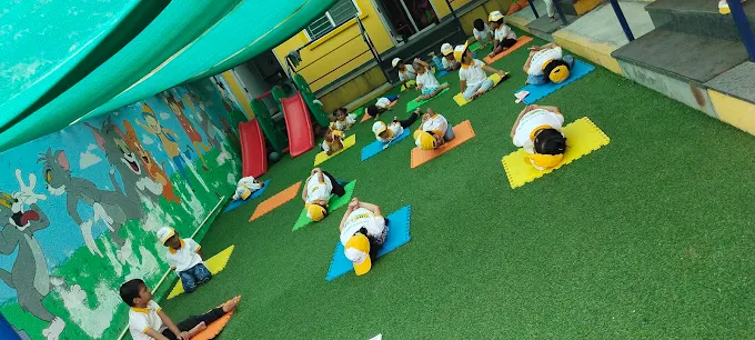 Children doing yoga poses on colourful mats